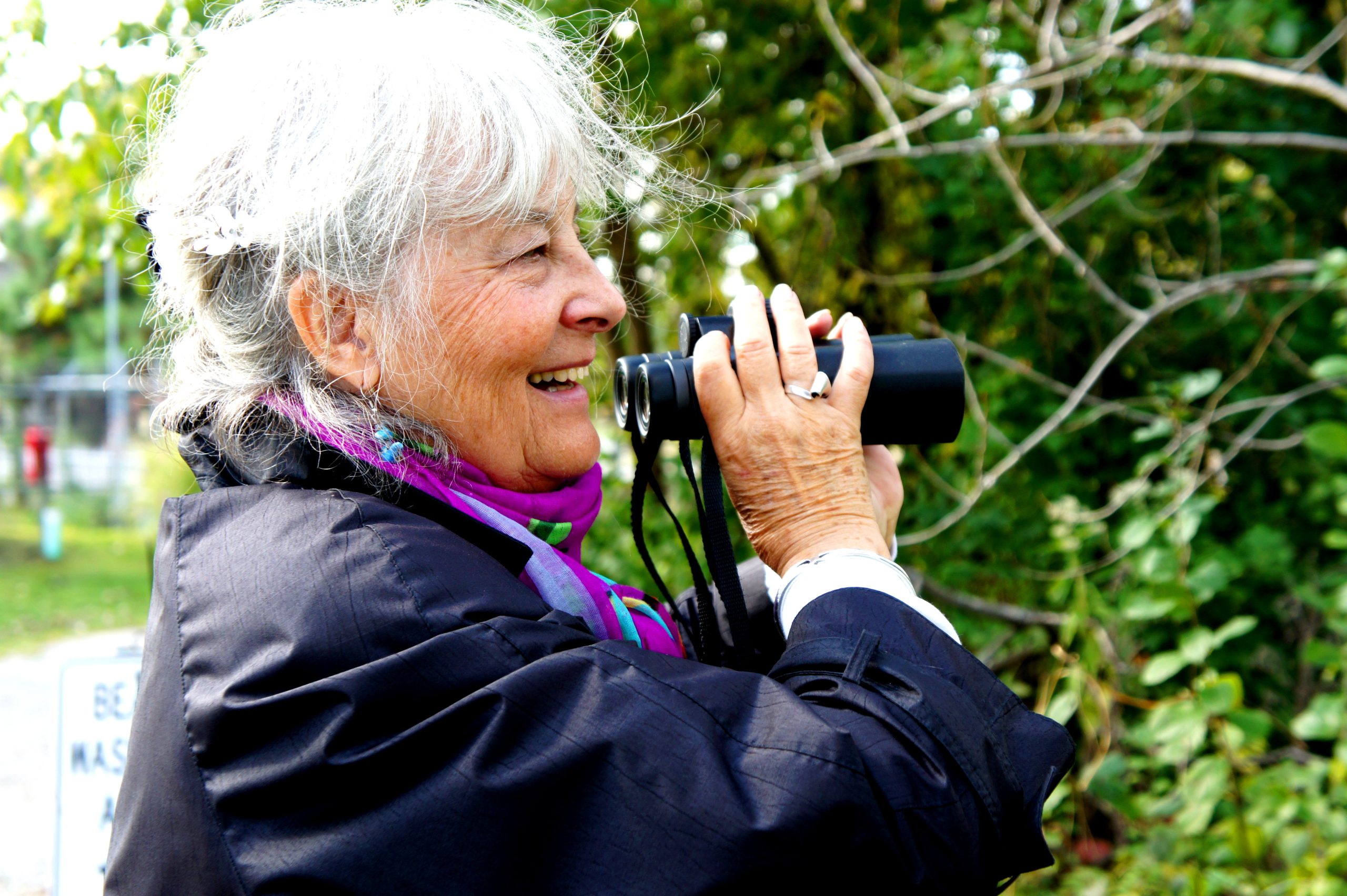 Carolyn Marsh spots sparrows in a bird sanctuary on the outskirts of Whiting Indiana, where a BP refinery now processes tar sands. (Credit Anna Simonton