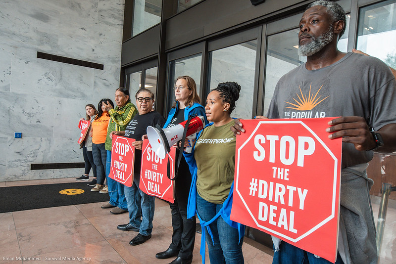Heads of US environmental organizations hold signs saying 